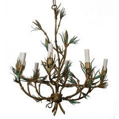 An antique faux bamboo wrought iron chandelier