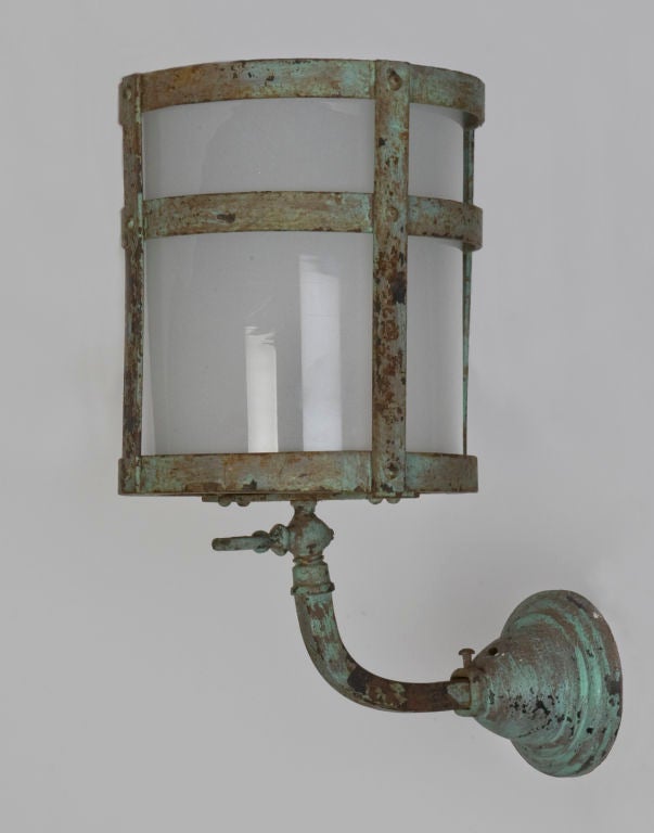 A pair of antique cylindrical wall lanterns