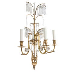 A pair of antique three-arm gilded crystal sconces