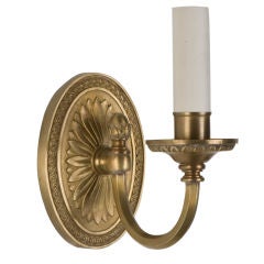 A pair of single-arm brass sconces by the Sterling Bronze Co.