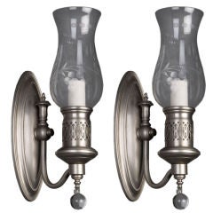 A pair of antique nickel hurricane sconces