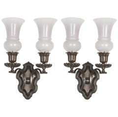 A pair of antique brass sconces by E. F. Caldwell