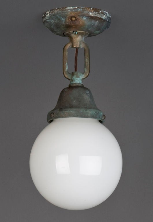 HL3521<br />
A vintage semi-flush fixture from a Baltimore tug with a milk-glass globe and bronze fittings in its original verdigris patina. <br />
<br />
Current height: 12 1/2