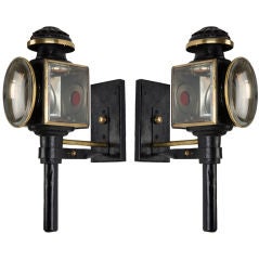 An Antique pair of black enamel carriage lights