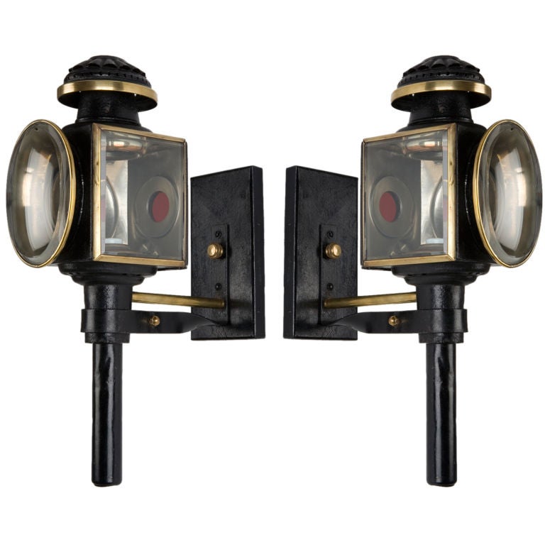 An antique pair of black enamel carriage lights