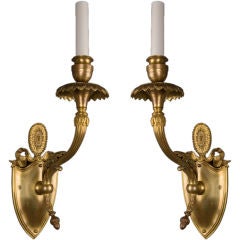 A pair of gilded sconces by the maker E. F. Caldwell
