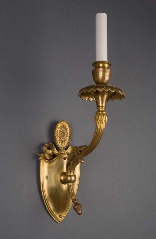 A pair of gilded sconces by the maker E. F. Caldwell