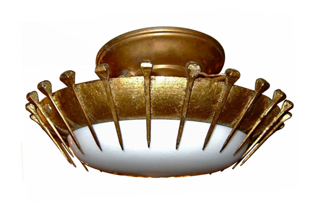 French gilt metal light fixture with milk glass inset, circa 1930.

Measurements:
Height 5.5?
Diameter 10?.