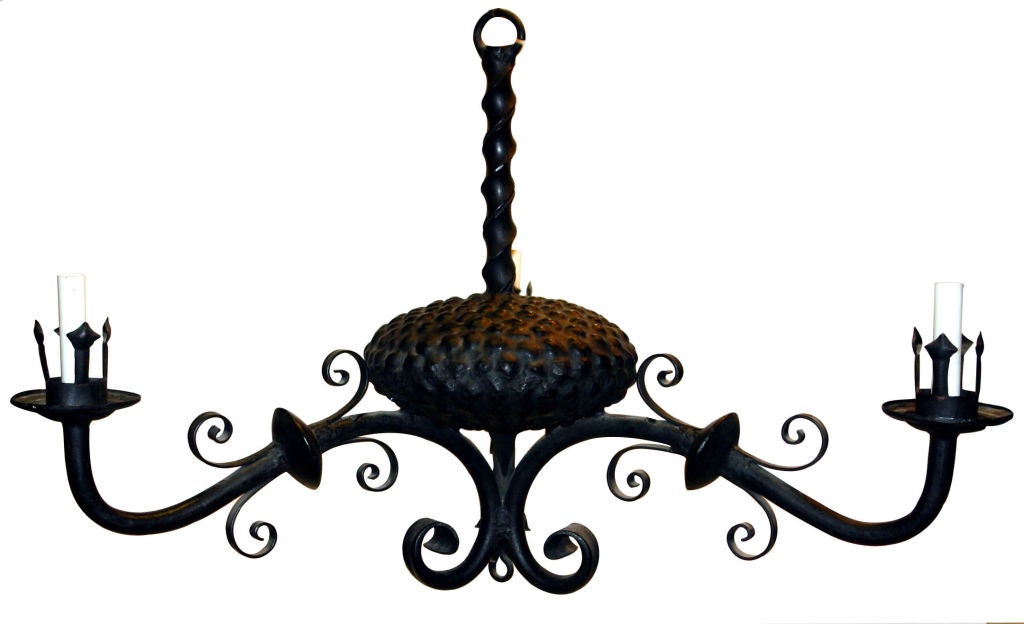 A Italian three-light wrought iron chandelier with a gourd shaped central body and scrolled details, circa 1900.

Measurements:
Height 23?
Diameter 34?.