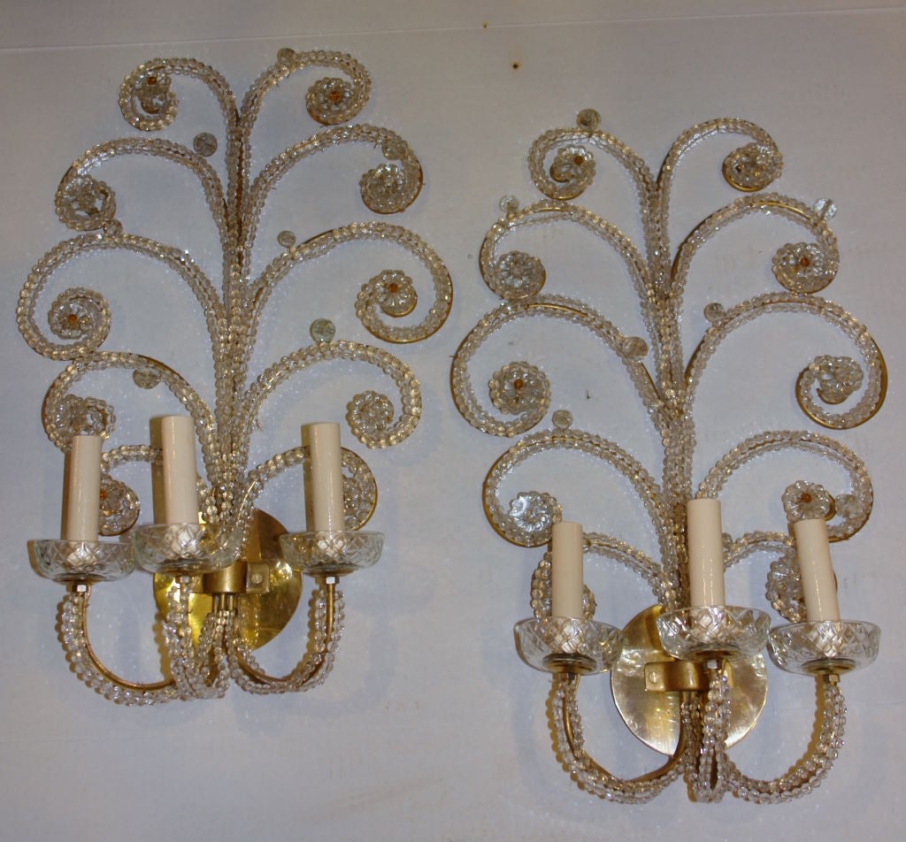 Pair of circa 1940s French gilt three-light sconces with beaded body and amber bead insets.

Measurements:
Height 22