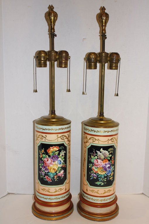 A pair of circa 1920s French porcelain table lamps with gilt and painted wood bases.

Measurements:
Height of body 16