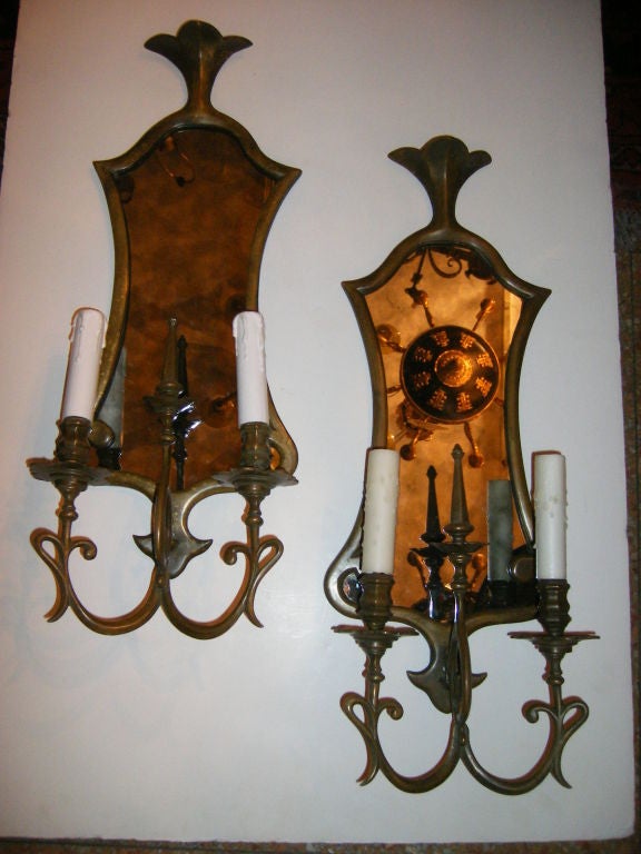Pair of circa 1930s, large American patinated bronze two-light sconces with mirror backplate. Arabesque detail on arms.

Measurements: 
24