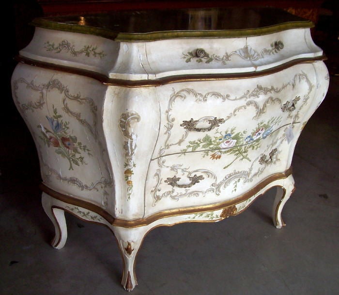 A Venetian painted bombay chest with faux marble top.