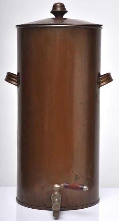 EXTRA LARGE ANTIQUE COPPER URN WITH A BRASS AND WOOD HANDLED SPIGOT.  COMMERCIAL SIZED COFFEE CONTAINER OR WATER COOLER.  TWO SIDE HANDLES AND A REMOVABLE LID.  GREAT DISPLAY PIECE