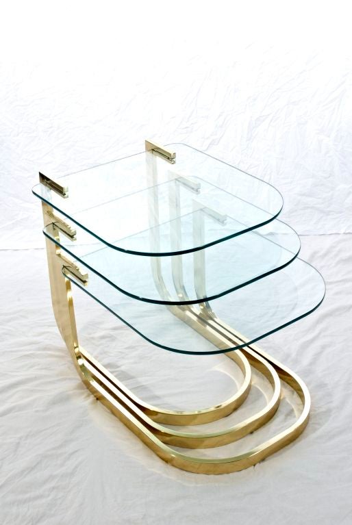 Set of three brass and floating glass nesting tables from the Design Institute of America.