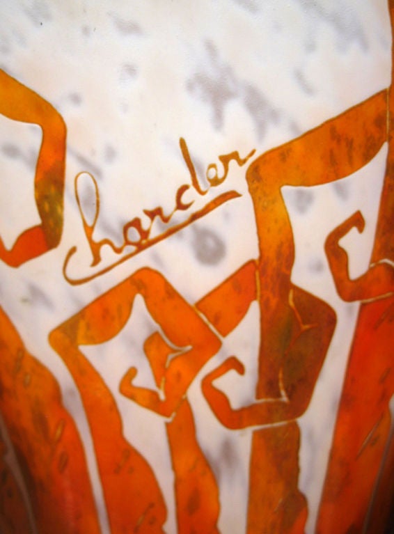 This impressive French art deco cameo glass vase was created by Charles Schneider (1881 – 1953) for his Le Verre Francais line.  The vase, in the “Fougeres” cutting depicts geometric ferns in mottled orange, red and green glass over a mottle white