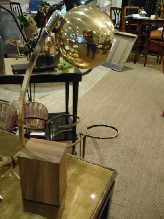 Brass desk lamp has wood block base.