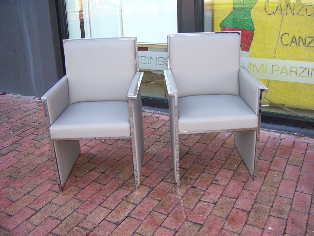 Chrome metal framed armchairs with modernist design, clean lines and quite comfortable.