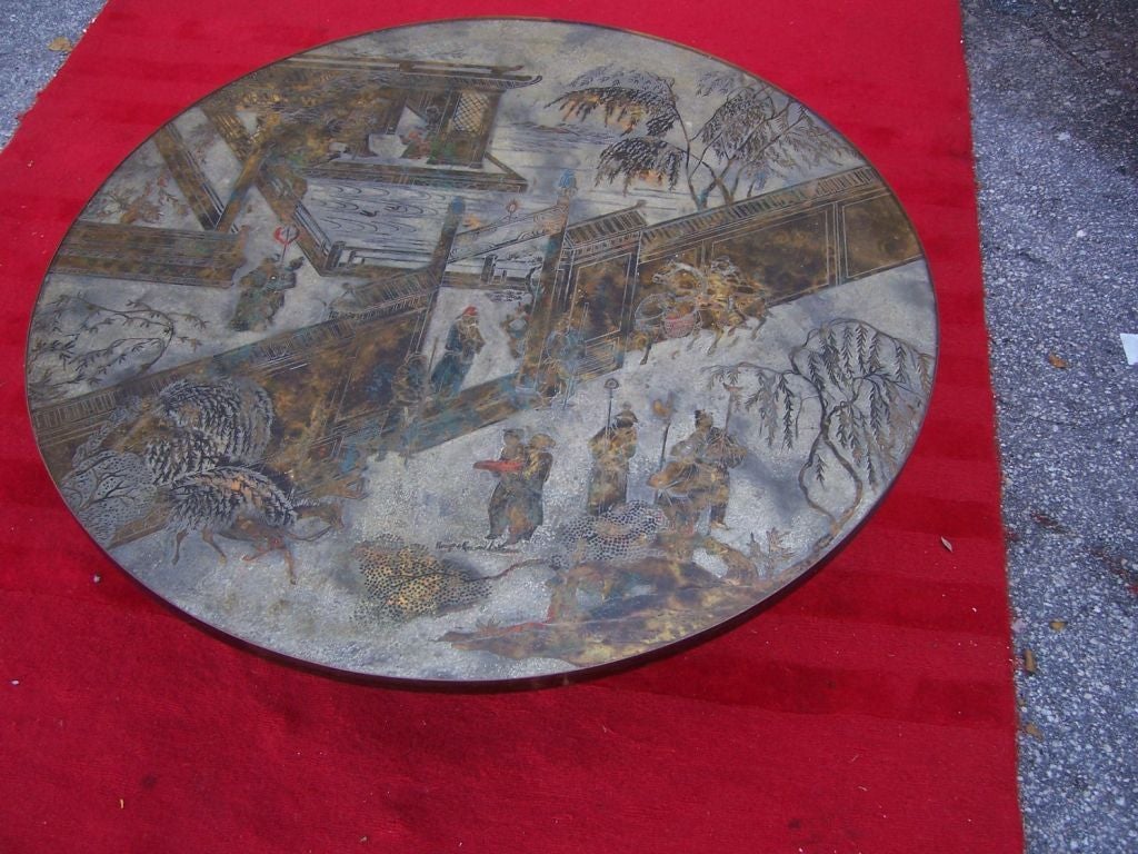 Phillip & Kelvin Laverne circular coffee table in acid etched bronze, pewter and enamel depicting a Chinese landscape with buildings and figures. Enameled bronze octagonal base. The table is richly patinated and colored.