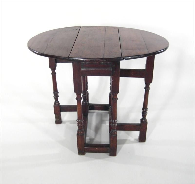 Colonial Revival Style Oak Gateleg Table with oval top, 2 hinged dropleaves, molded apron and baluster turned legs,   Perfect as side table, bedside table or occasional cocktail or coffee table.