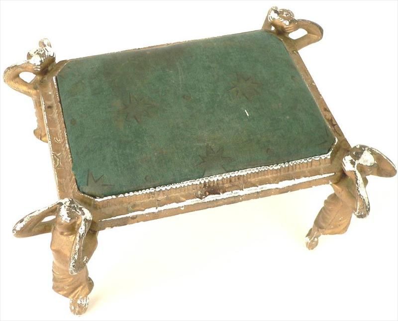 1920's cast metal petite foot stool with female figure at each corner.