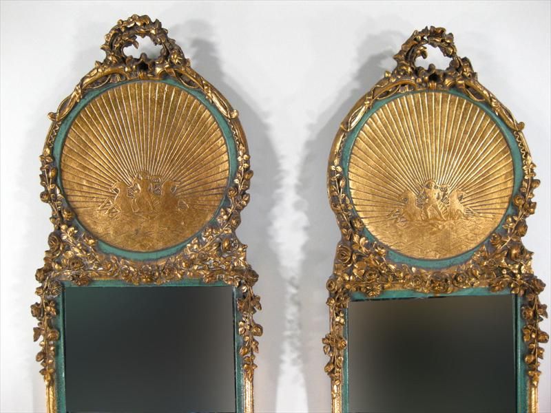 Pair of Louis XV Style Gilded & Painted Narrow Mirrors with sunburst and Aurora at the top, putti and amorous figures at the bottom.
