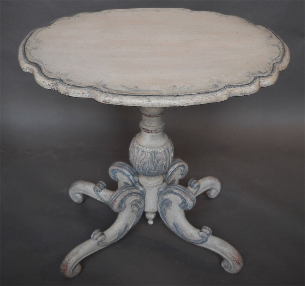 Tea table, Denmark circa 1860, with heavily carved pedestal supported by three carved and painted legs. Secondary white paint is highlighted with detailing in a soft blue.