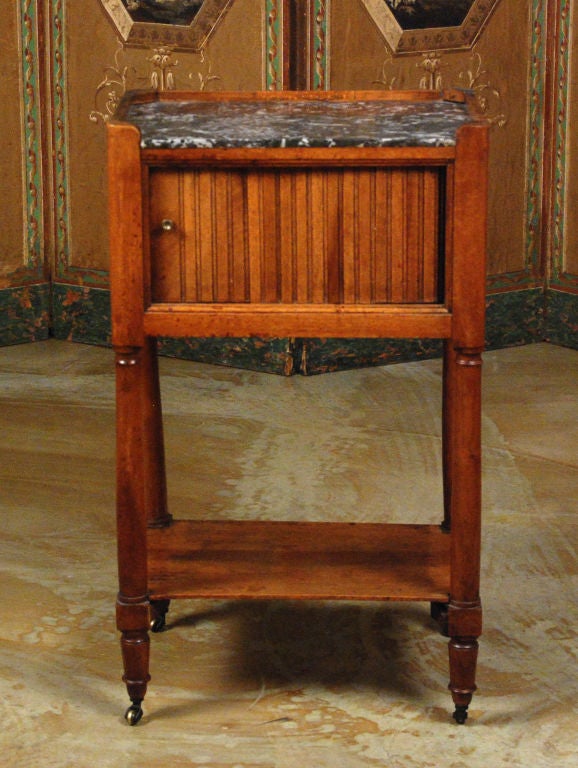 A Louis XVI Fruitwood Marble Top Stand with Tambour Door