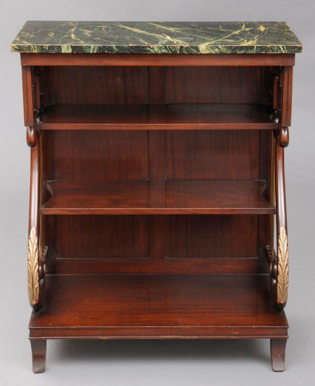 Late Regency mahogany pier or console table with faux green marble top, sides with S-scrolls and Greek key design, brass upright rods, gilded leaf carving on scroll supports, two shelves, all on splayed bracket feet. Can also be use as a book stand.