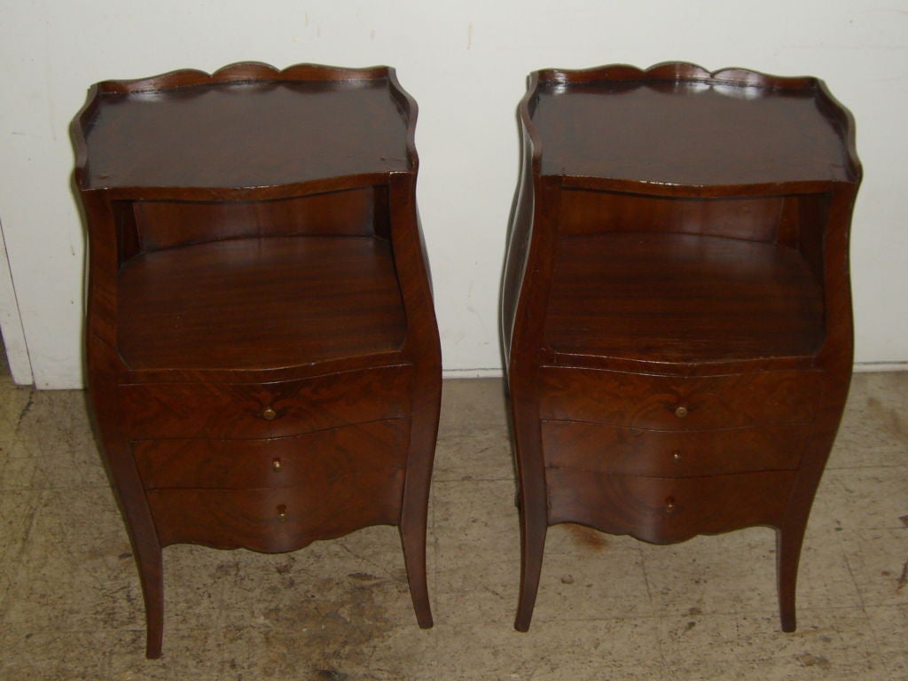 A nice pair of French marquetry inlaid bombay end tables or night stands. They have nice detail and while we had our restorer polish them and replace most of the lost veneer, we did not restore these to perfection as they look nice as they are. We