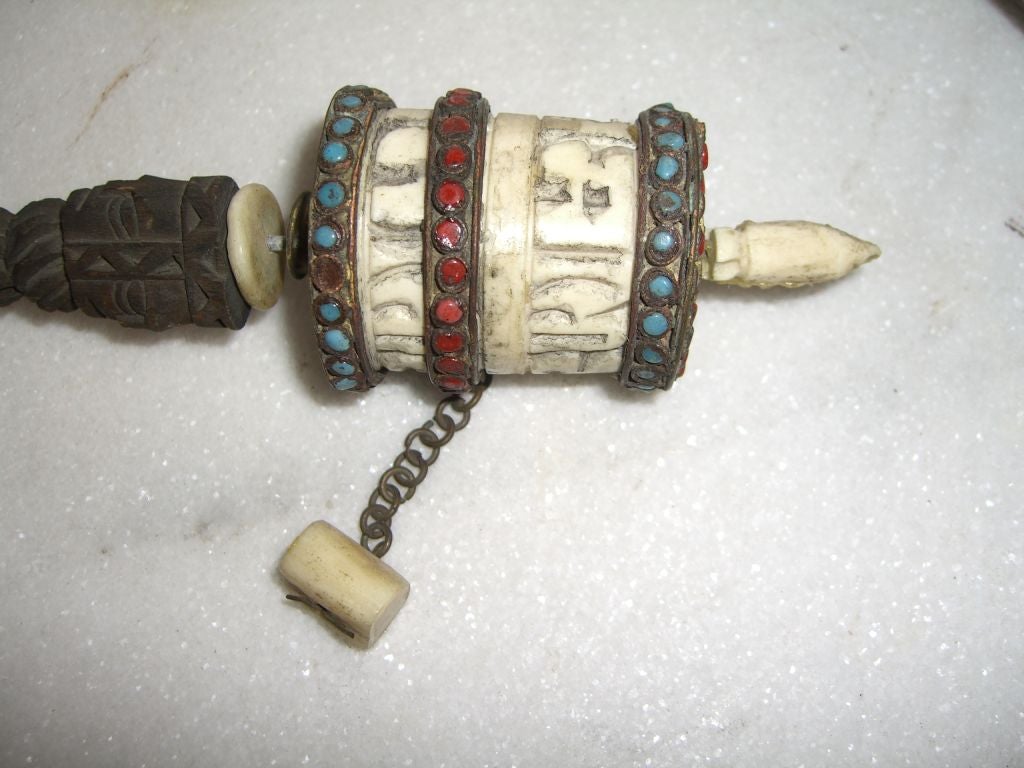 A lot of three interesting probably Tibetan ceremonial drums or noisemakers. They are intricate and interesting. One is metal studded with stones and with an attached ringer?. Another is bone or ivory and wood with a bone or ivory ringer, and the