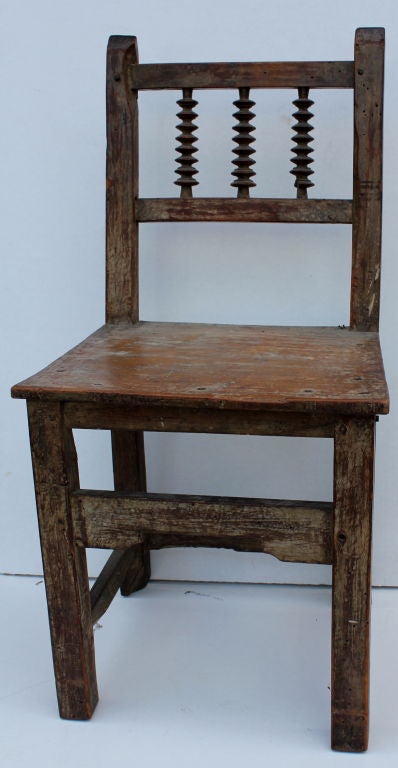 A whimsical pair of hand carved chairs most likely Spanish colonial and from New Mexico , Santa Fe. They are quite old and may be older the the 18th century having been redone many times. They are sturdy.  Great patina to the wood. There is quite a