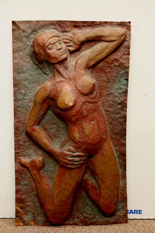 A great hand hammered copper plaque of a nude probably black woman. Because of the depth of the piece it appears that the artist pressed a copper plate onto a carving or cast piece and hand hammered the pattern into the copper. I may be wrong as