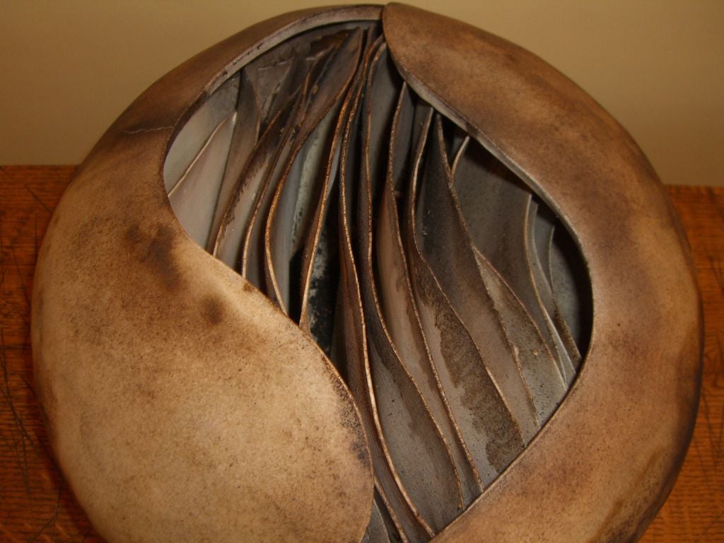 This incredible piece of pottery was done by an Evanston Illinois potter who signed her work Ruth Weiner. It has layers of terracotta that appear to be leaves in side the piece. Nice glaze and size make this an outstanding piece of pottery.
