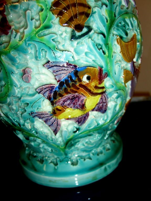 A truly whimsical and wonderful piece of Italian Majolica that is incredibly well crafted. It is incised and appears almost enameled. It is signed or inscribed by the artist on the base and also stamped with the company's logo. The handle has been
