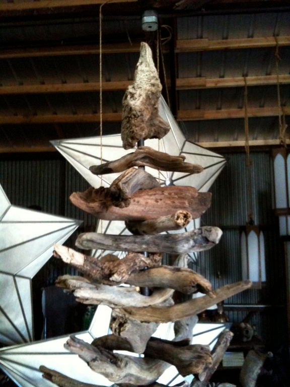another delightful spoonful from matt.  the driftwood tree is upon a solid wood base with a metal pole that is detachable.  each branch is taken on and off, one at a time.  each branch is drilled and is shown with the longest branches starting at