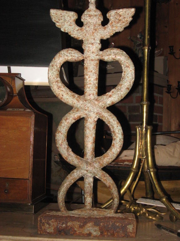 Antique iron Hippocratic symbol made into lamp.