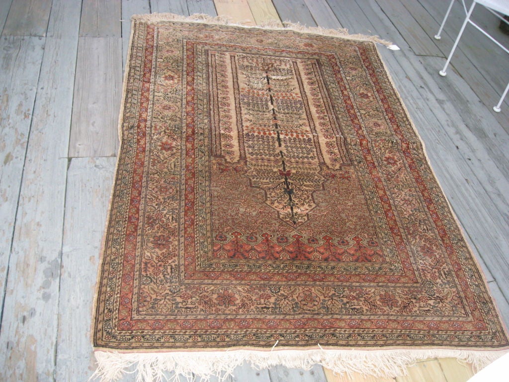 Silk oriental prayer rug in beiges and light browns.