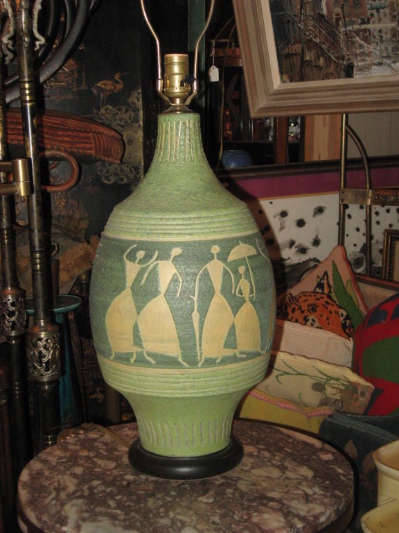 Mid-Century Italian handmade pottery lamp with figures in two shades of green and yellow on wood base.