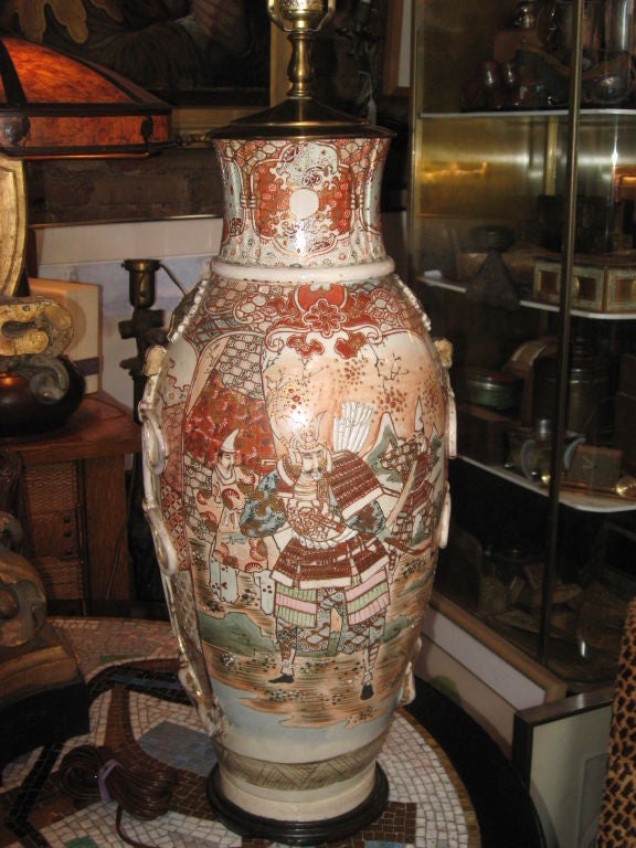 Monumental 19th century Japanese Satsuma vase made into a lamp. Salmon like colors a wood base.