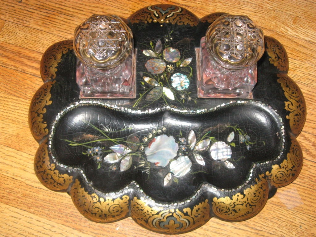 19th century papier mâché and mother-of-pearl with elaborately carved inkwells.