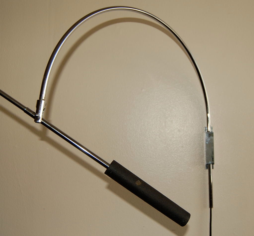 Wall mounted lamp by American designer Robert Sonneman. Lamp can swing out and adjust up or down at the pivot point, with the lamp head also being adjustable. The lamp arm is 32