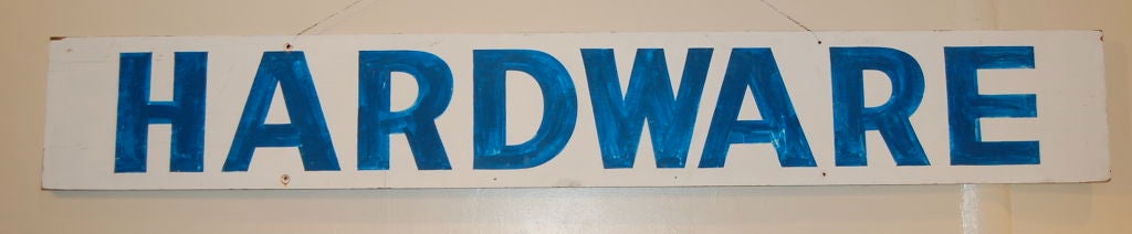 Rustic hardware store signage, with the lettering in a wonderful color of  blue paint on wood.