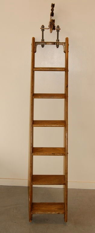 Warehouse ladder constructed of oak still retaining the hanging hardware.