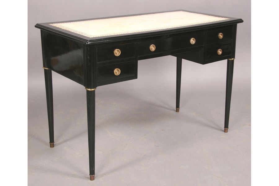 A nice small-scale bureau plat in ebonized wood with inset white leather top and 5 drawers, one stamped 