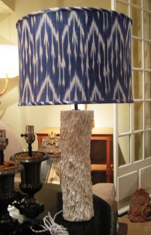 A pair of custom lamps made from reclaimed wood specimens, in white lacquer, with custom silk Ikat shades.