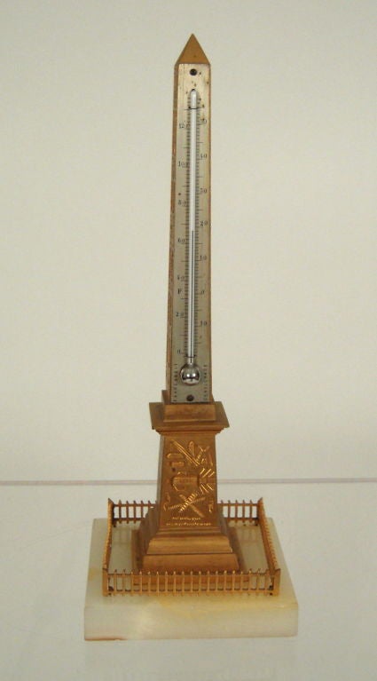 A 19th century French Grand Tour neoclassical gilt bronze model souvenir of the Egyptian obelisk from Luxor, now installed where the guillotine used to be in the center of the Place de la Concorde in Paris, mounted on a white marble base, with