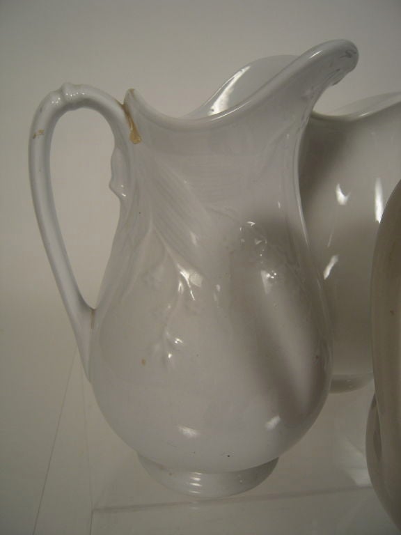 A collection of 7 19th century English Staffordshire and American  white ironstone pitchers of various sizes and patterns, ranging in height from 9 1/4 