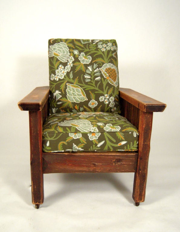 A large Arts and Crafts period Morris Chair in carved pine with adjustable back, retaining its original Paine Furniture Company paper abel, newly upholstered, with new down cushions in green crewel work fabric. <br />
Provenance: A. Piatt Andrew,