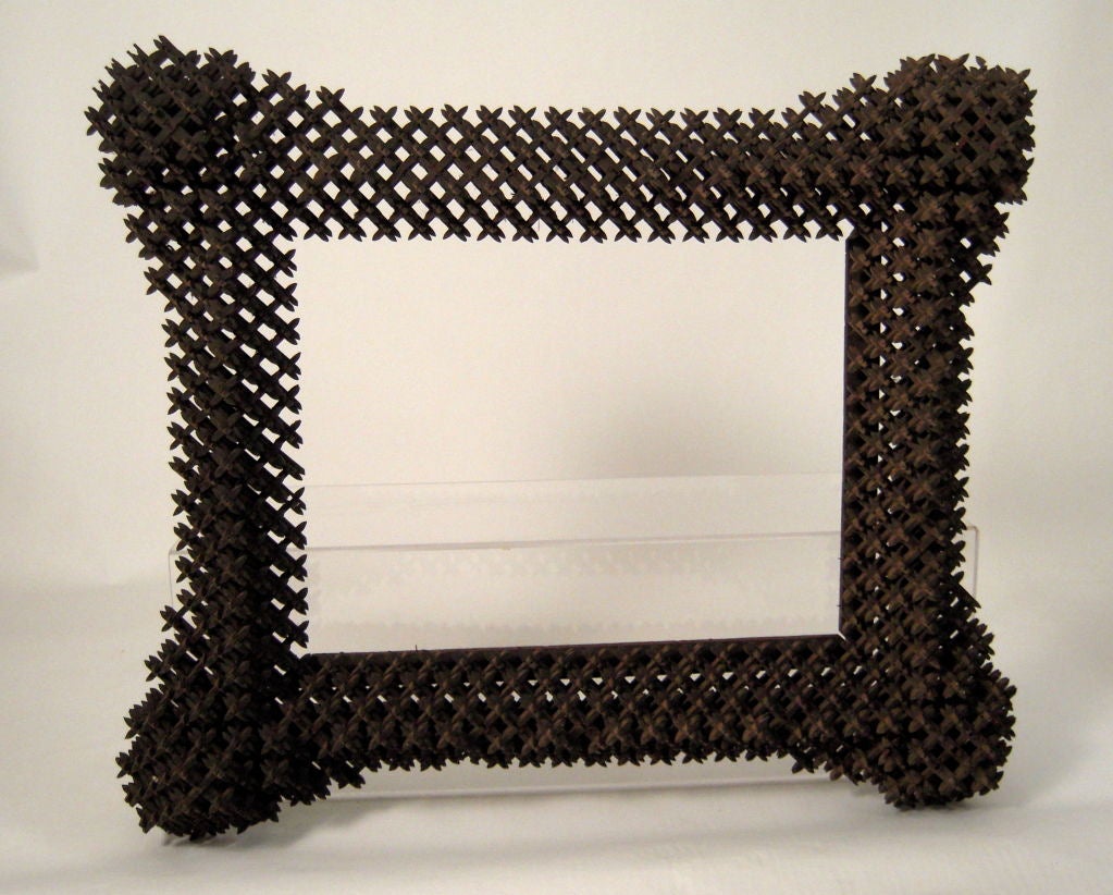 A large, graphic 'crown of thorns'  tramp art frame, with elaborately carved and constructed wooden 'pegs. Great size and depth.